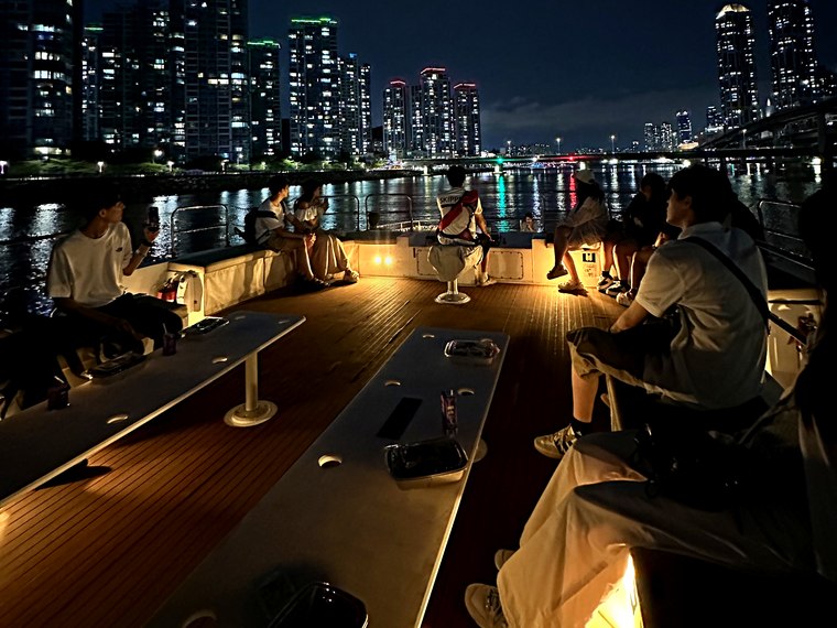 夜景を背景にデッキに集まった団体のお客様